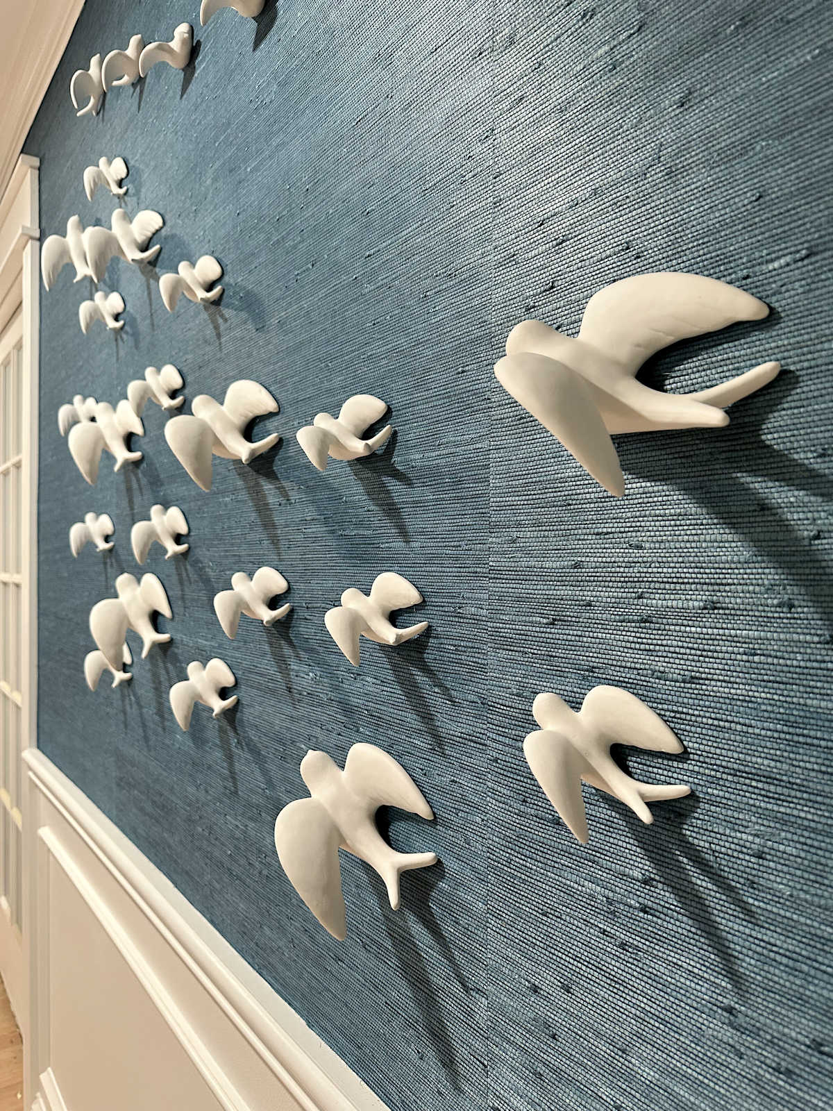 ceramic bird art installation on bedroom wall - 48 birds
